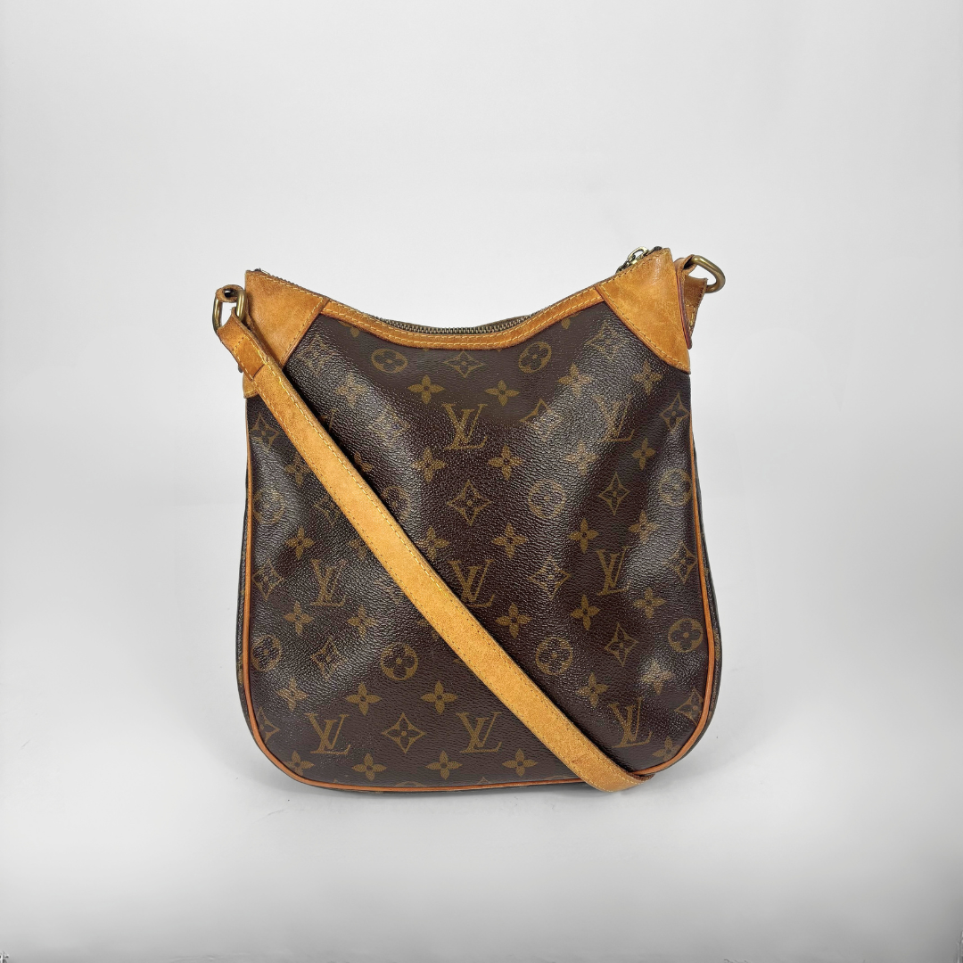 Designer handbag with monogram pattern on a light gray background