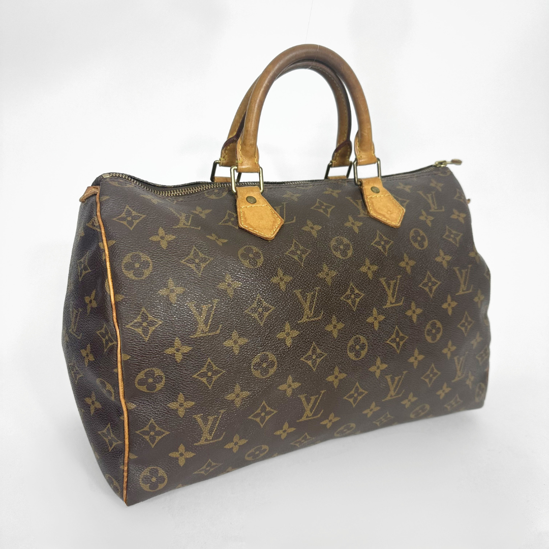 Brown handbag with a monogram pattern on a white background