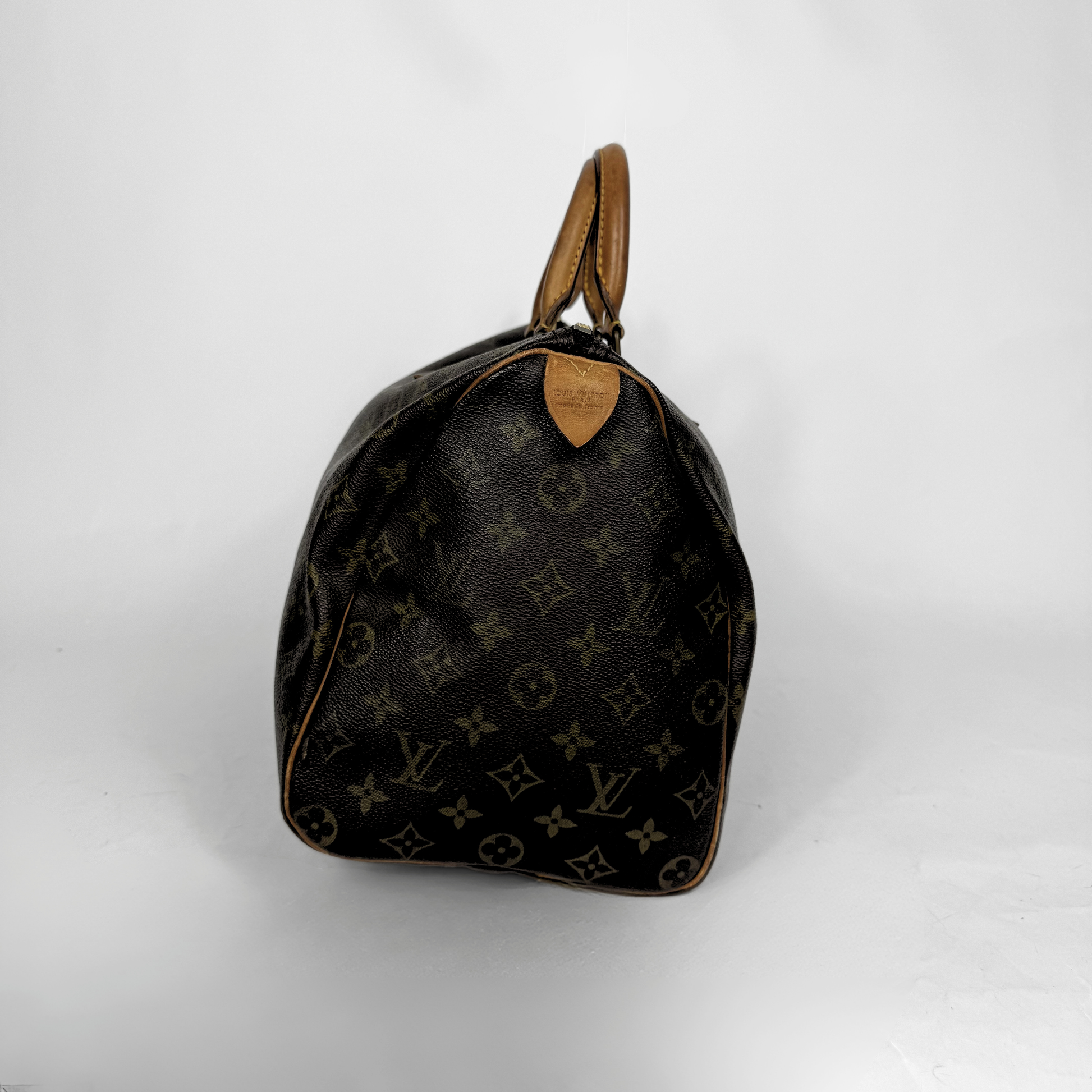 Designer handbag with monogram pattern on a white background