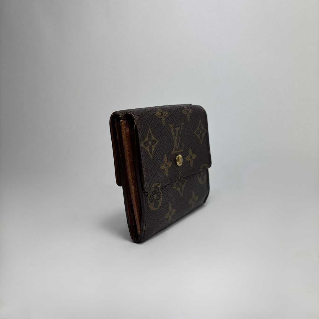 A Louis Vuitton monogram canvas wallet in dark brown with gold-tone hardware, photographed on a light gray studio background.