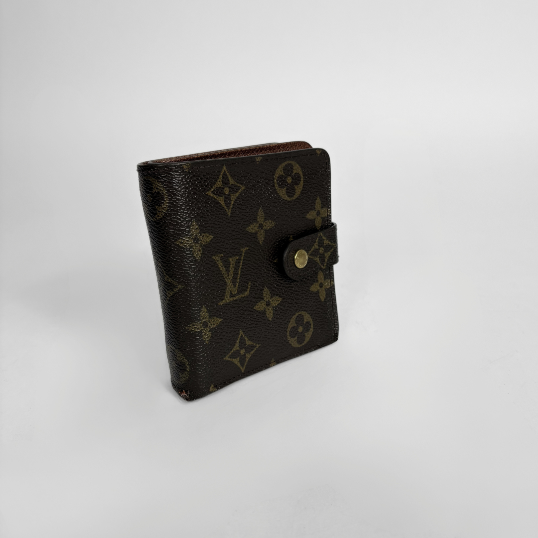 Brown LV wallet with gold accents on a light gray background