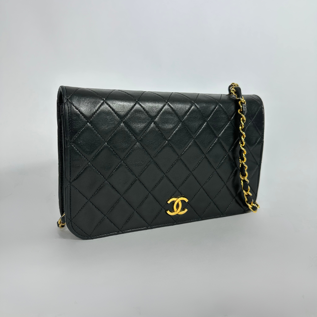 Black Chanel bag on white background