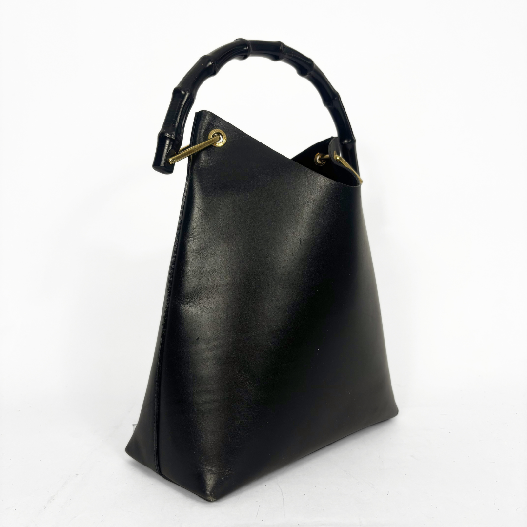 Gucci vintage black leather hobo hag with a dark wood bamboo top handle and gold-tone hardware.