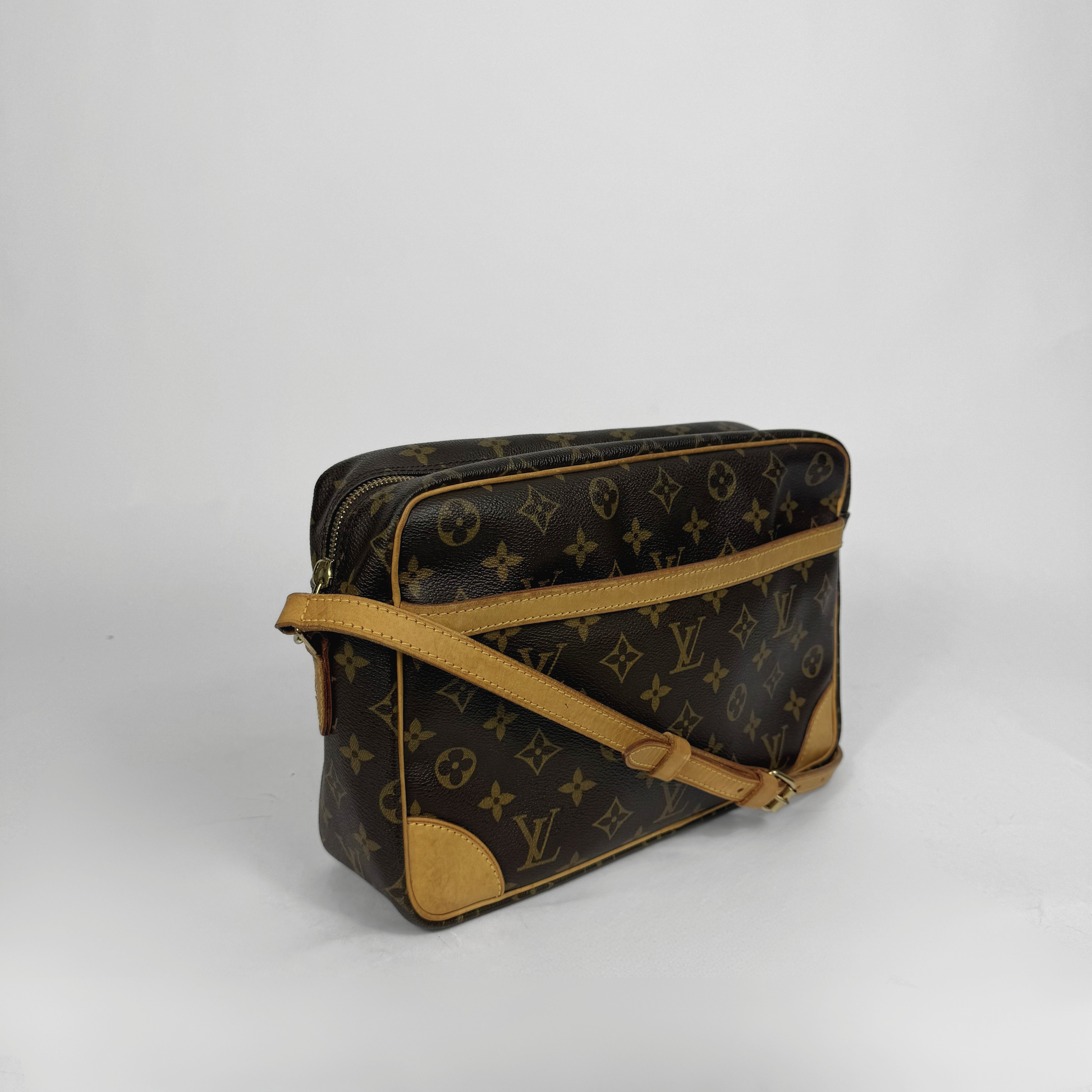 Brown handbag with gold monogram pattern 