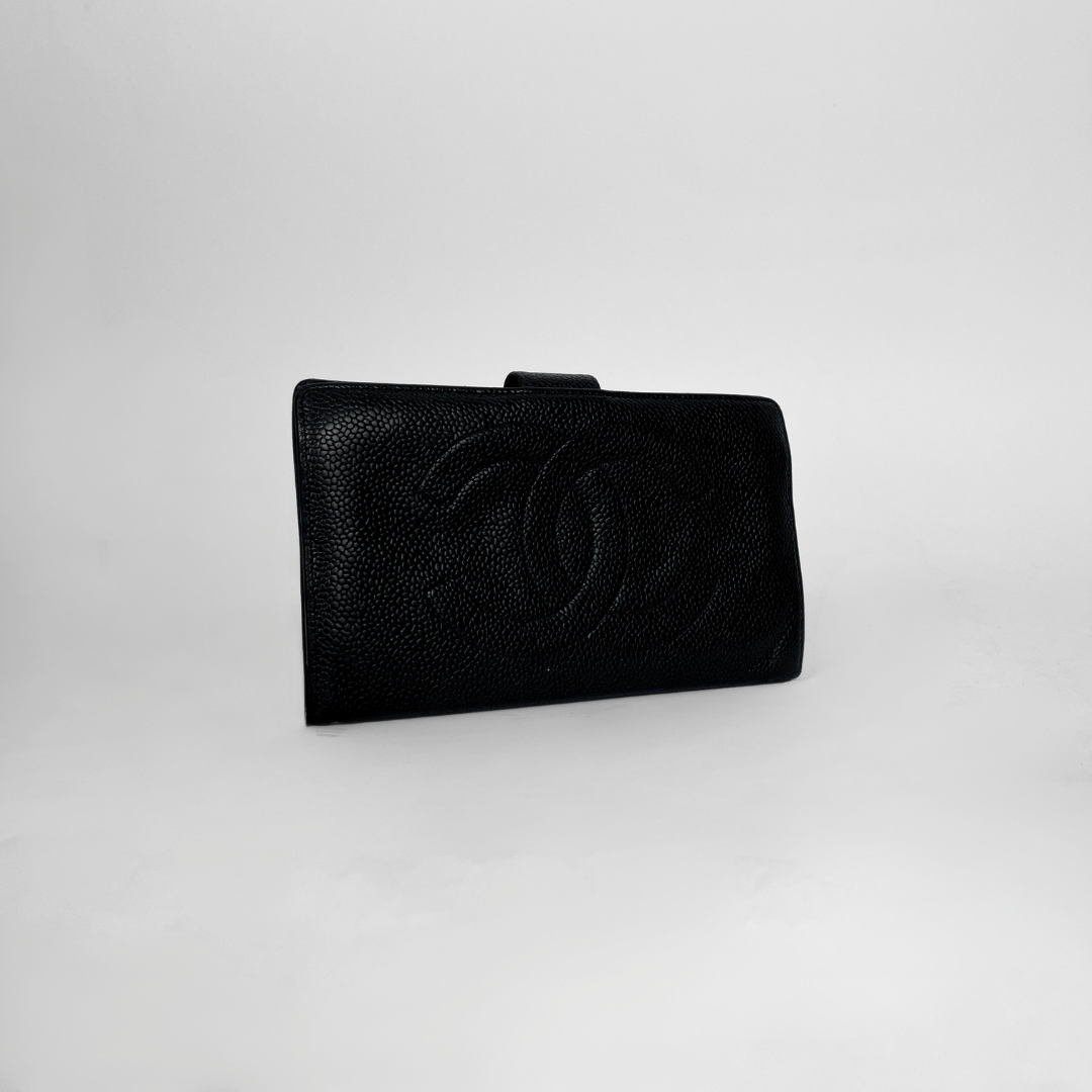 A black textured leather clutch bag with an embossed interlocking CC logo, characteristic of Chanel, set against a plain light gray background.