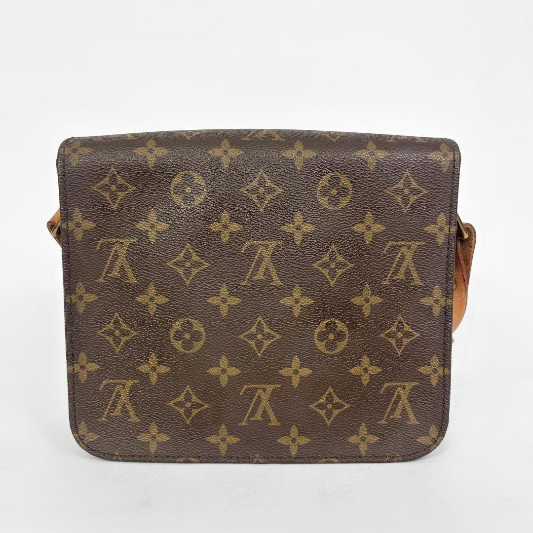 Louis Vuitton monogram handbag on a light gray background