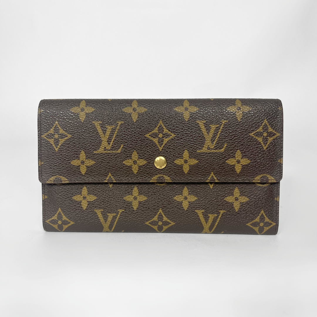 Louis Vuitton wallet with monogram pattern on a white background