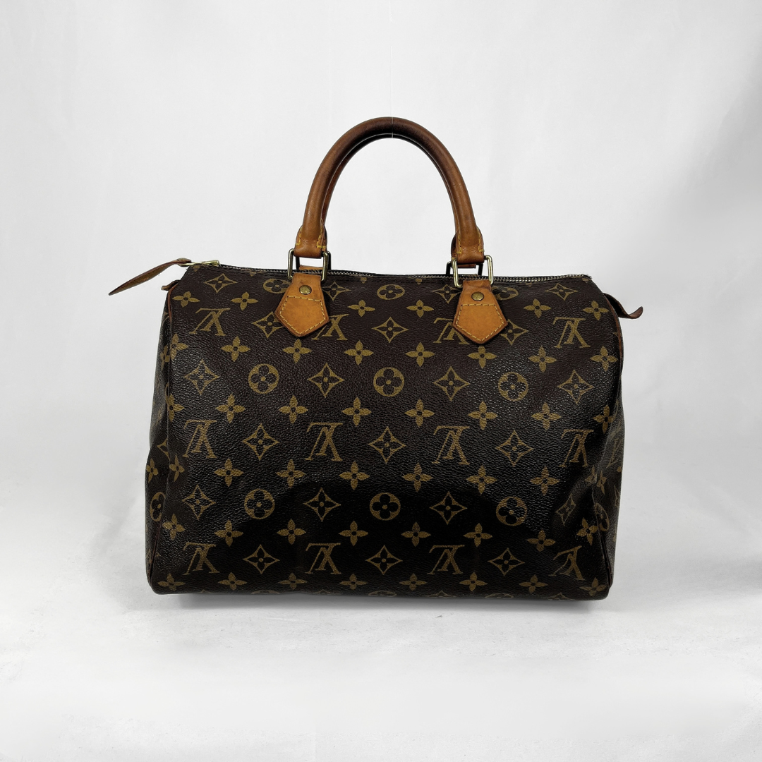 Louis Vuitton monogram canvas duffel bag with brown leather handles and trim, photographed against a plain white background.