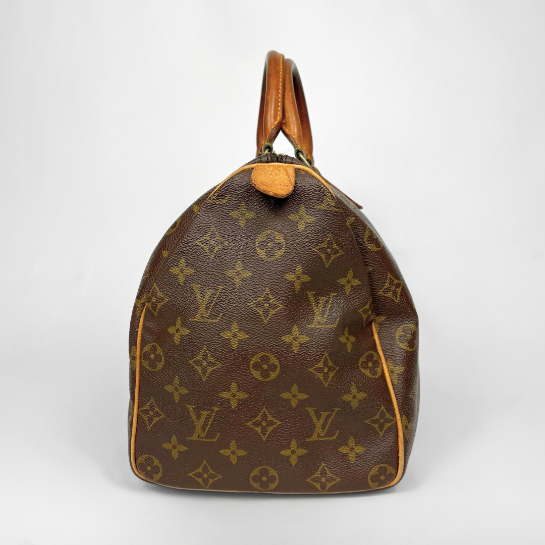 Brown Louis Vuitton bag with monogram pattern on a white background