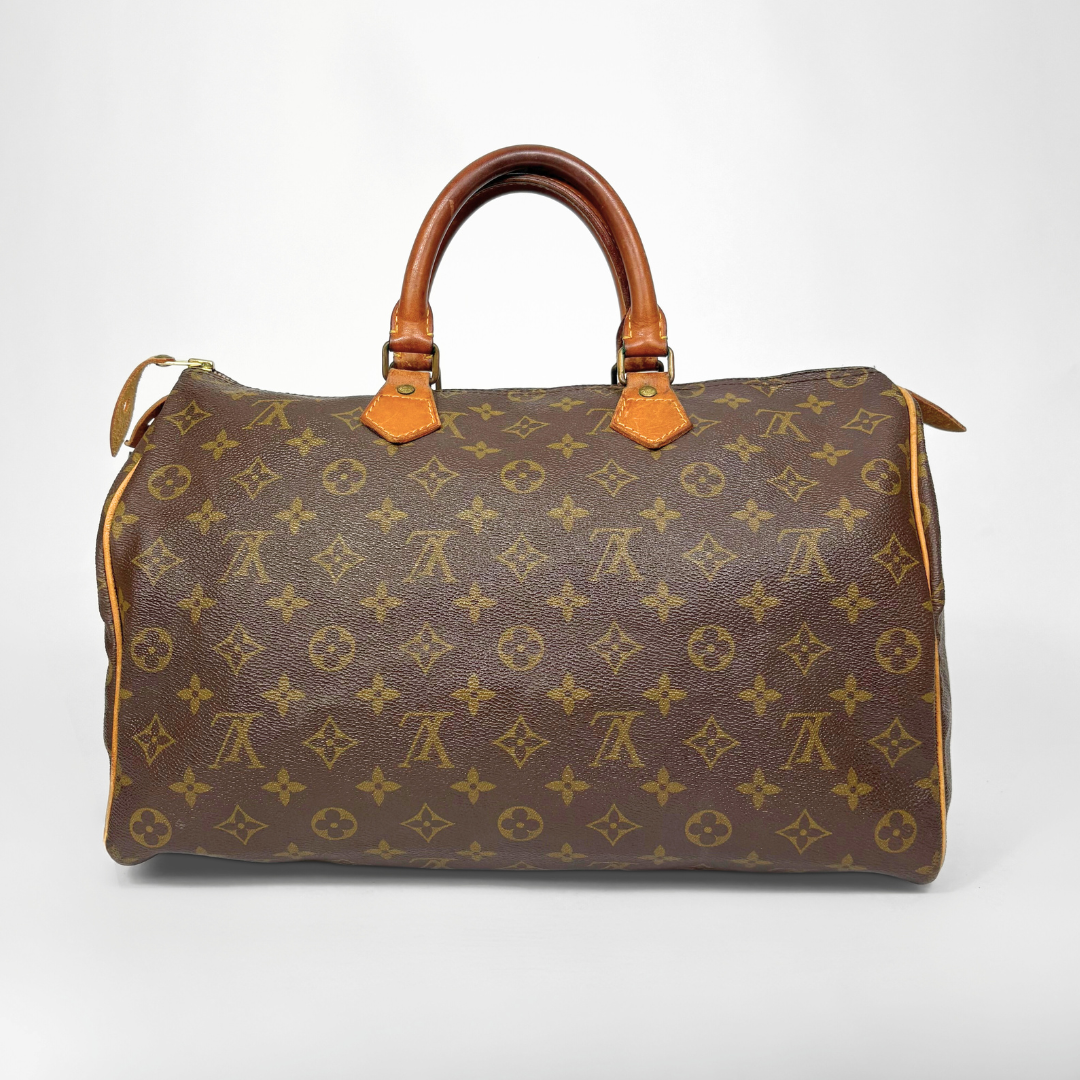 Brown handbag with monogram pattern on a white background