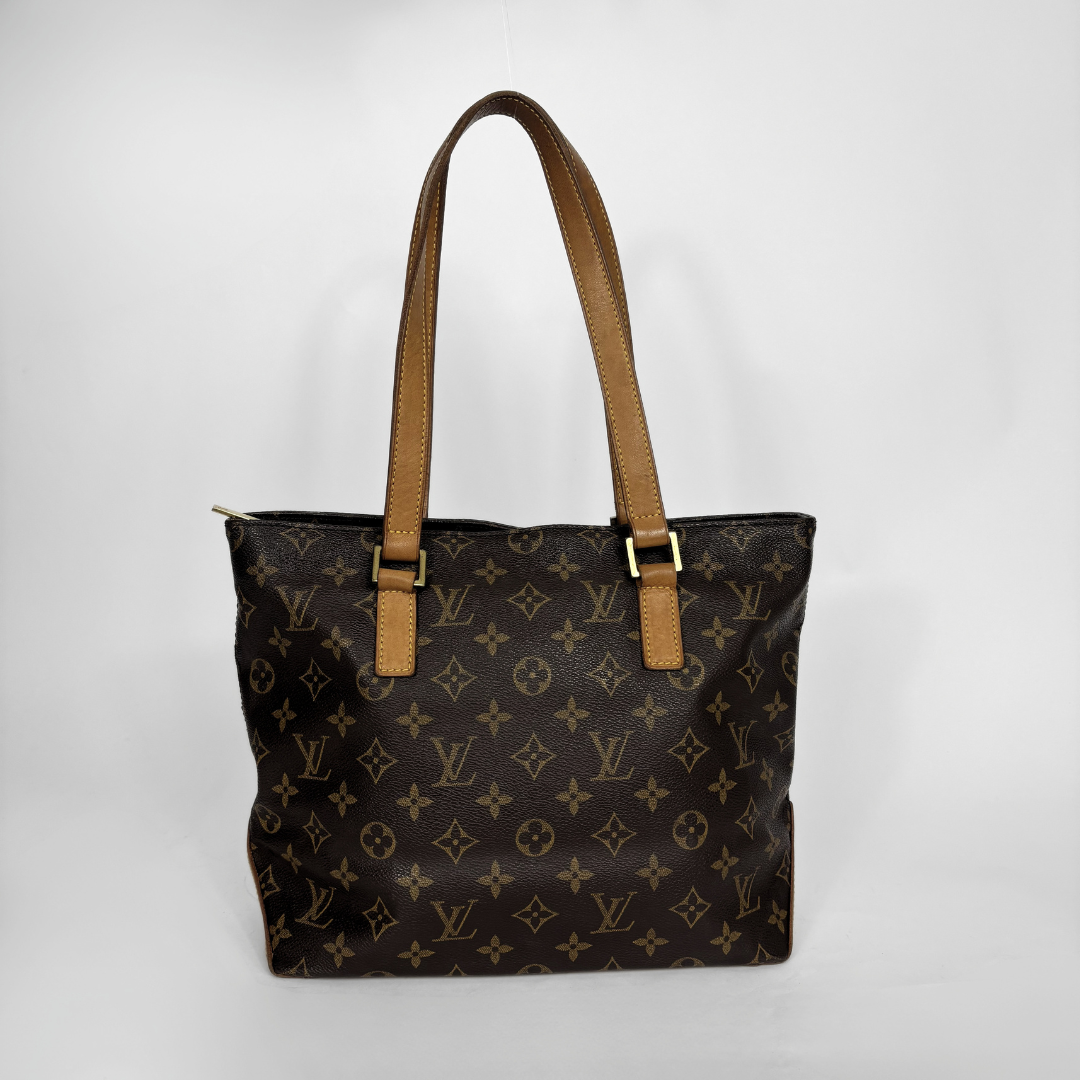 Louis Vuitton monogram canvas tote bag with tan leather shoulder straps and gold-tone hardware, photographed against a plain light gray background.