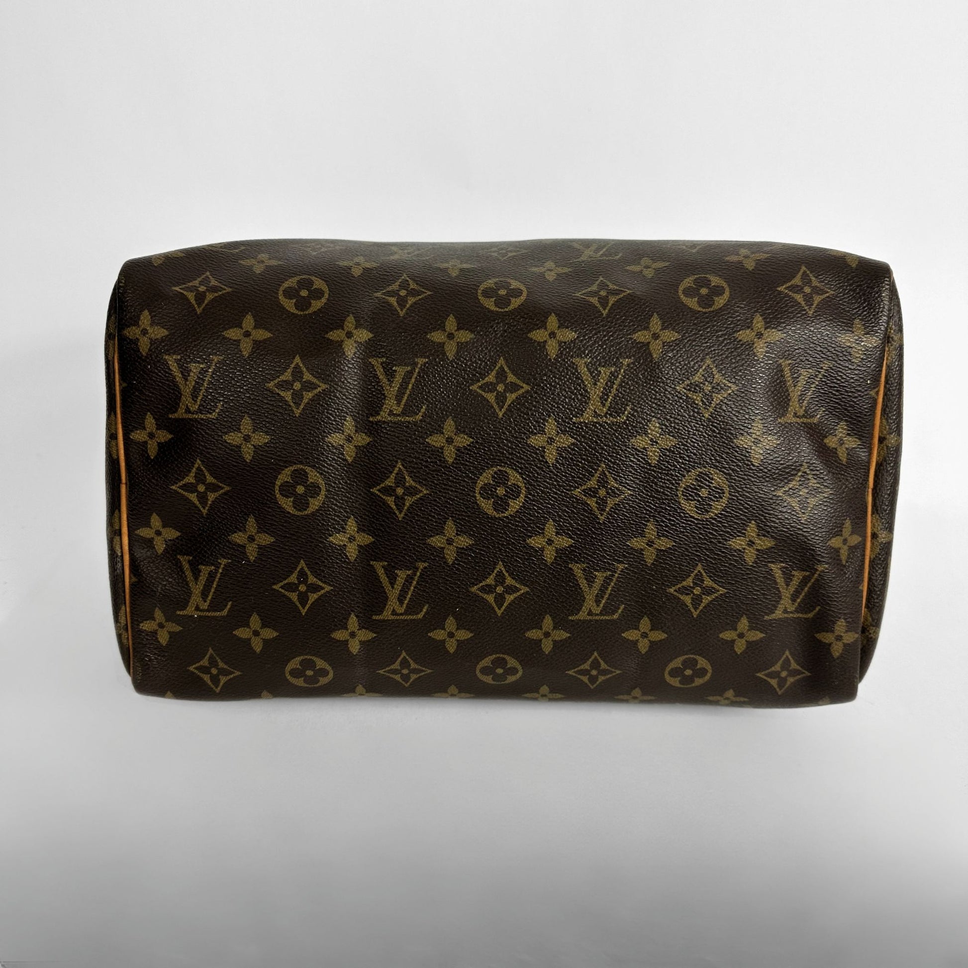 A Louis Vuitton monogram canvas shoulder bag in dark brown with tan/gold LV logos and floral motifs, photographed against a neutral light gray background.