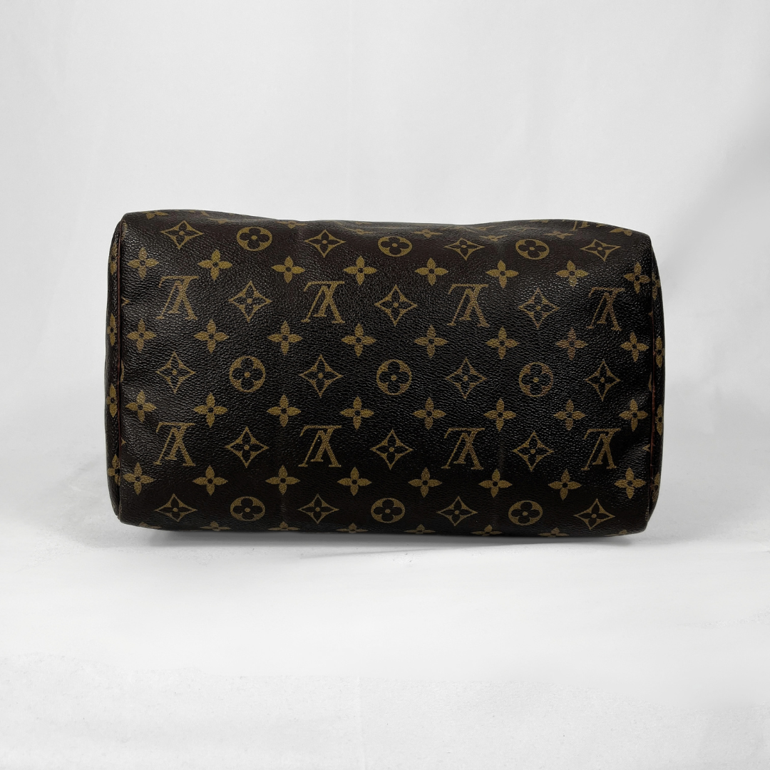 A Louis Vuitton monogram canvas shoulder bag in dark brown and tan, photographed against a plain white background.
