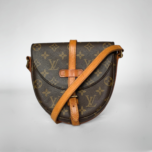 Designer handbag with monogram pattern on a light gray background