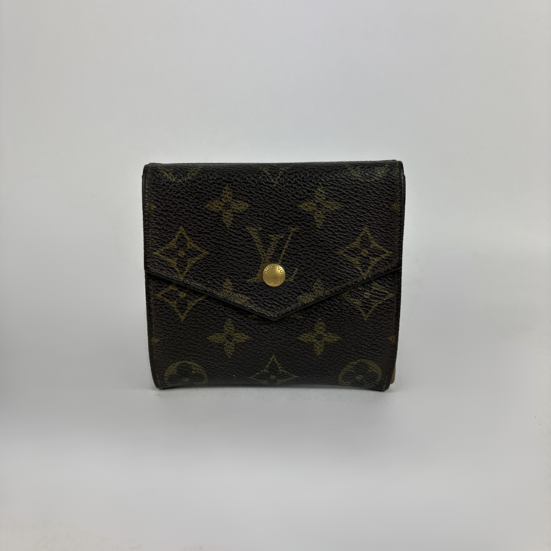 A Louis Vuitton monogram canvas bi-fold wallet in dark brown with gold-tone hardware, photographed against a neutral light gray background.