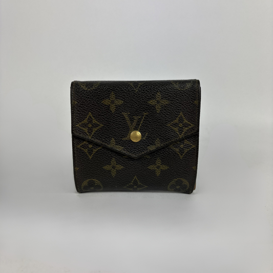 A Louis Vuitton monogram canvas bi-fold wallet in dark brown with gold-tone hardware, photographed against a neutral light gray background.
