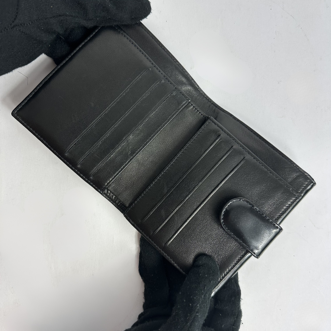 Black Chanel wallet on white background