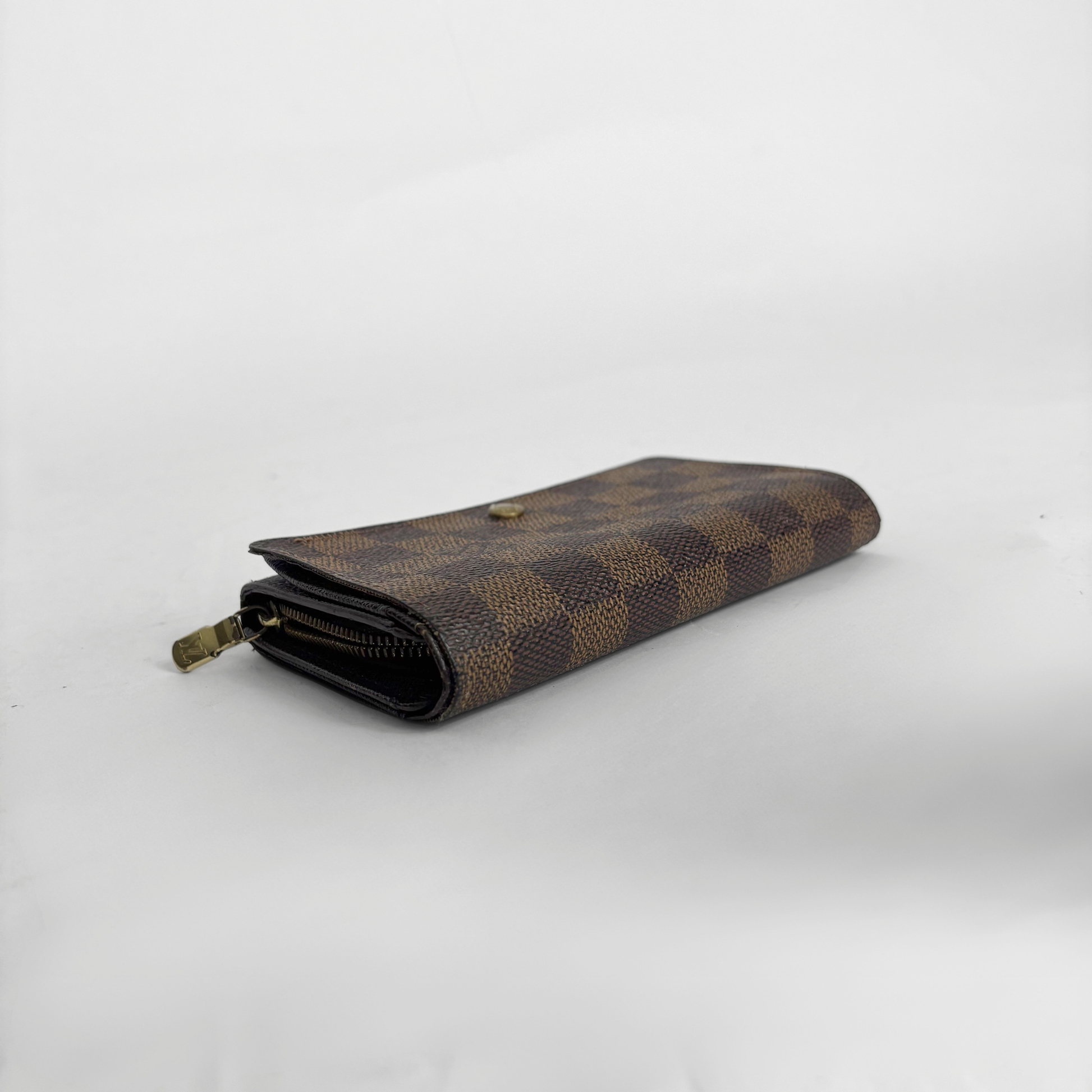 Louis vuitton wallet in brown Damier Ebene checkered canvas with a snap-button closure.
