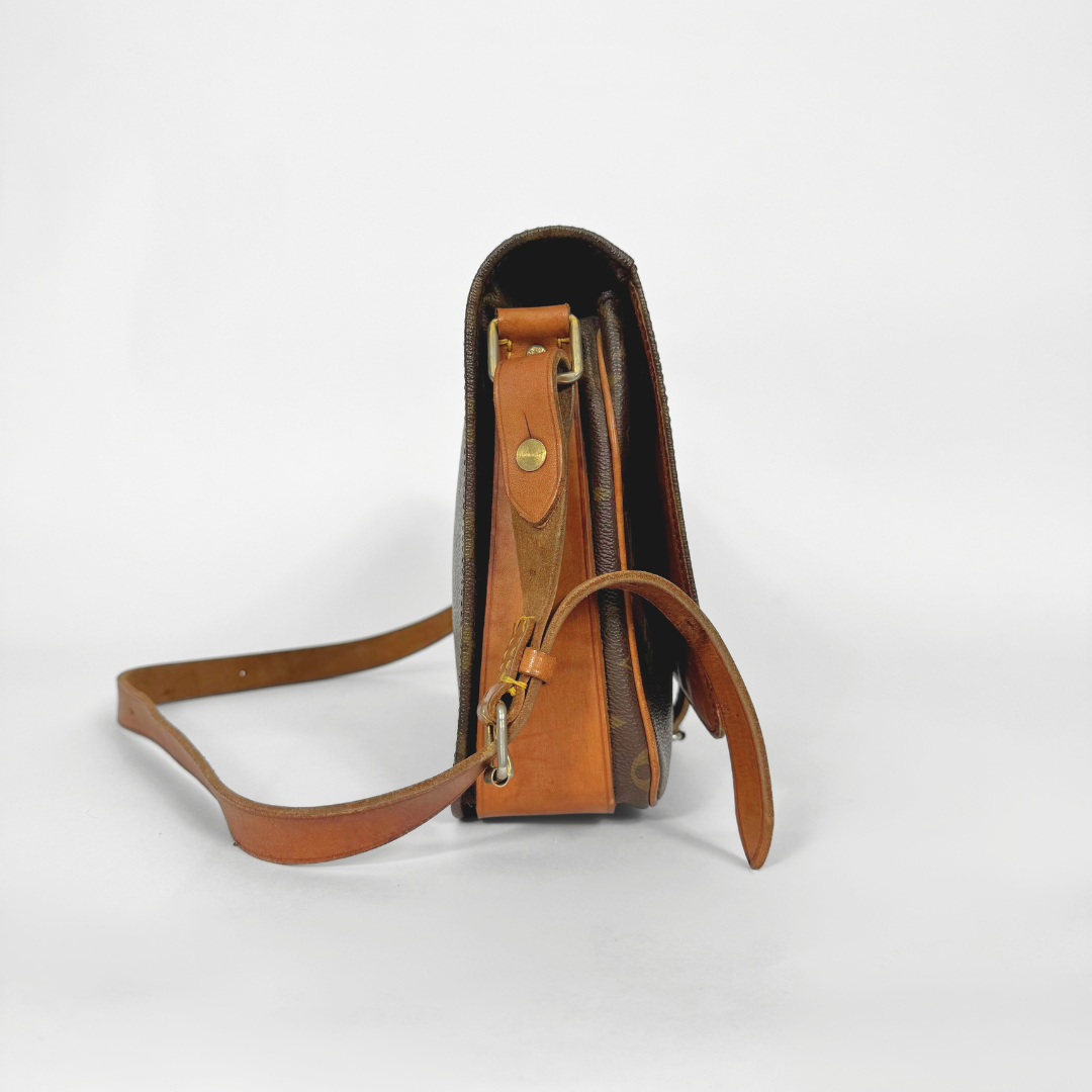 Brown leather crossbody bag on a white background