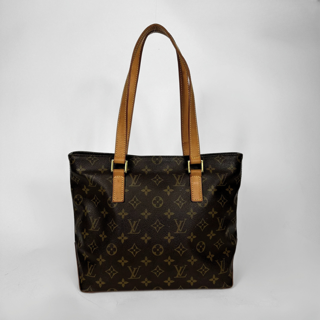 Louis Vuitton monogram canvas tote bag with tan leather shoulder straps and gold-tone hardware, photographed against a light gray studio background.