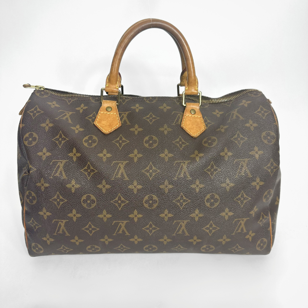 Brown handbag with a monogram pattern on a white background
