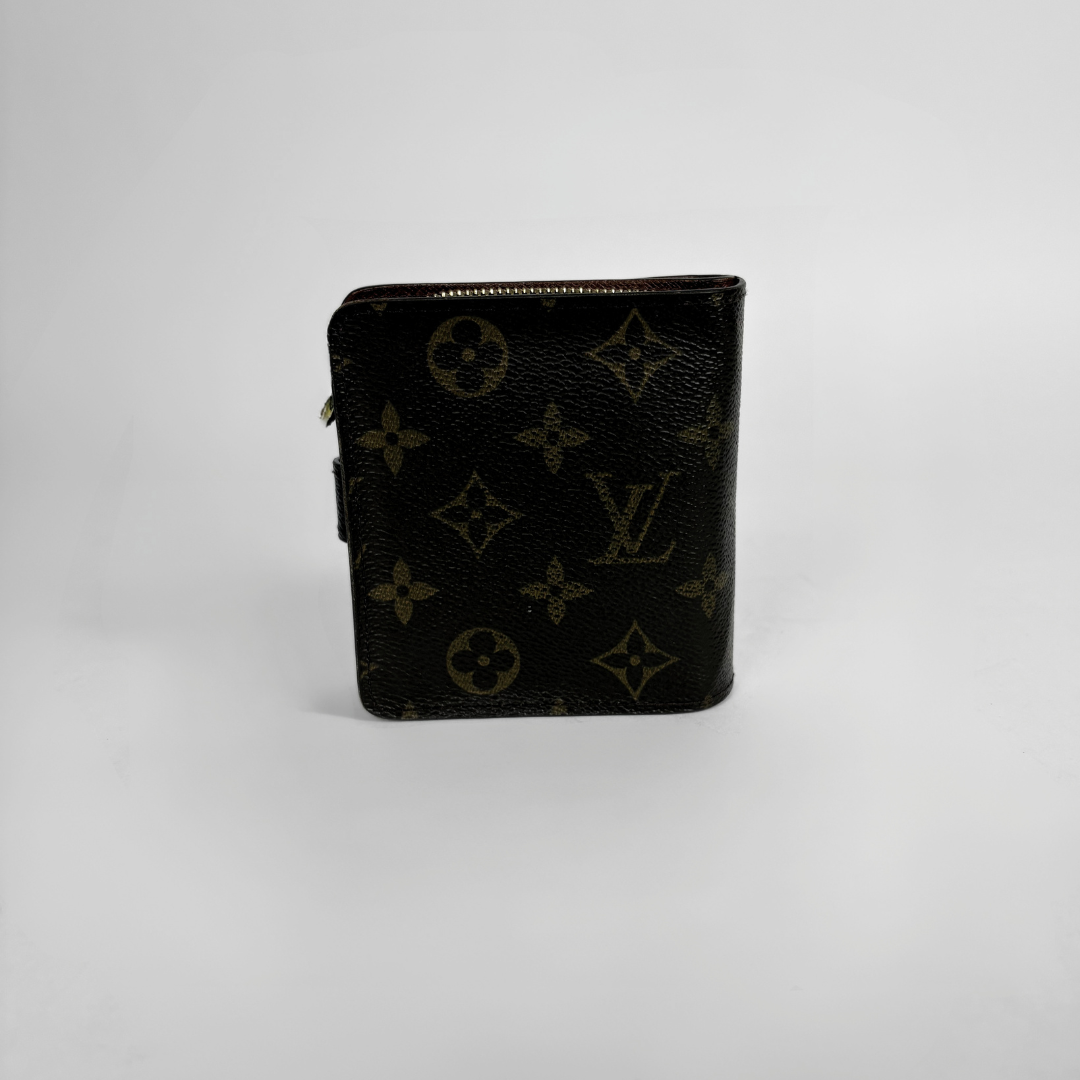 Brown LV wallet with gold accents on a light gray background
