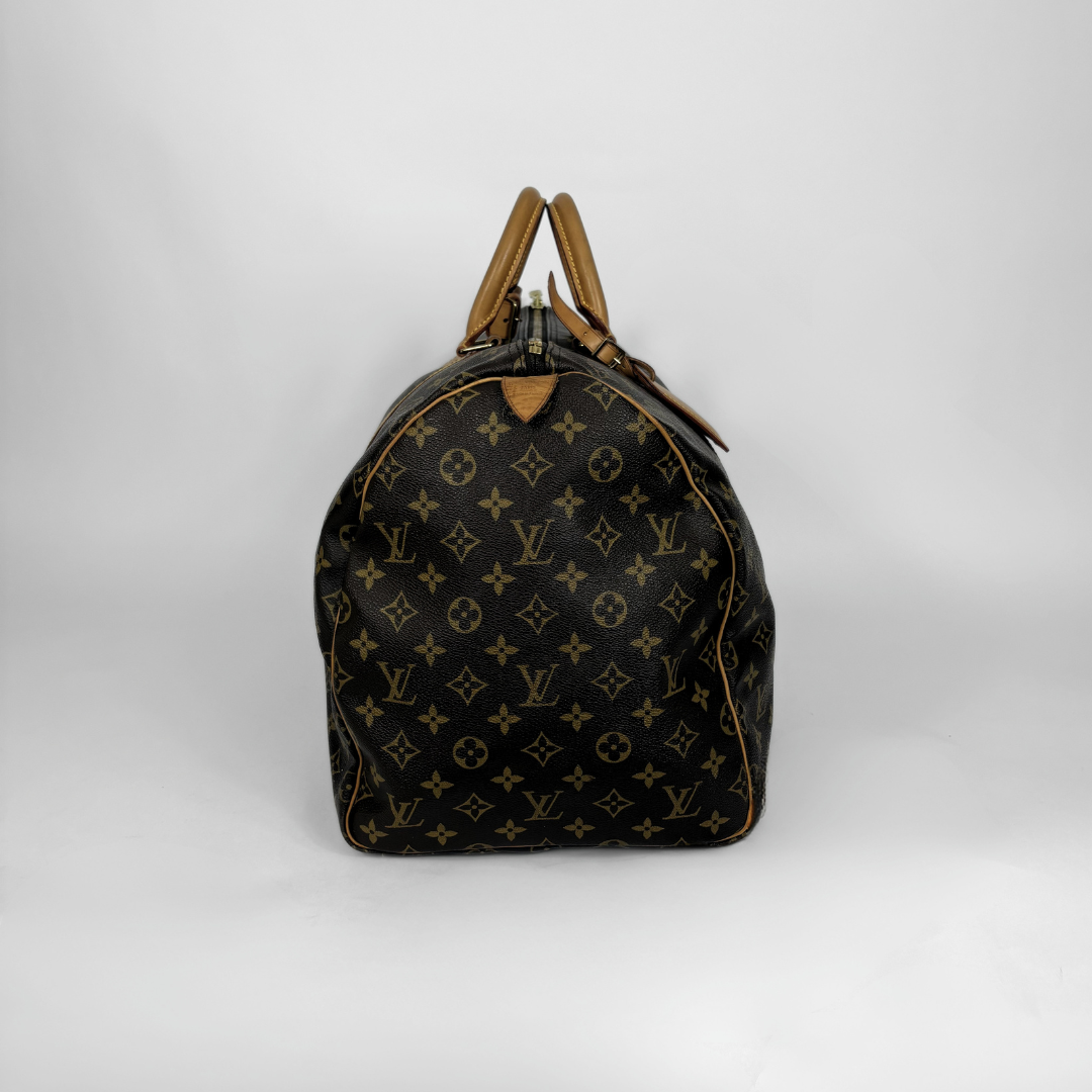 Designer handbag with monogram pattern on a white background