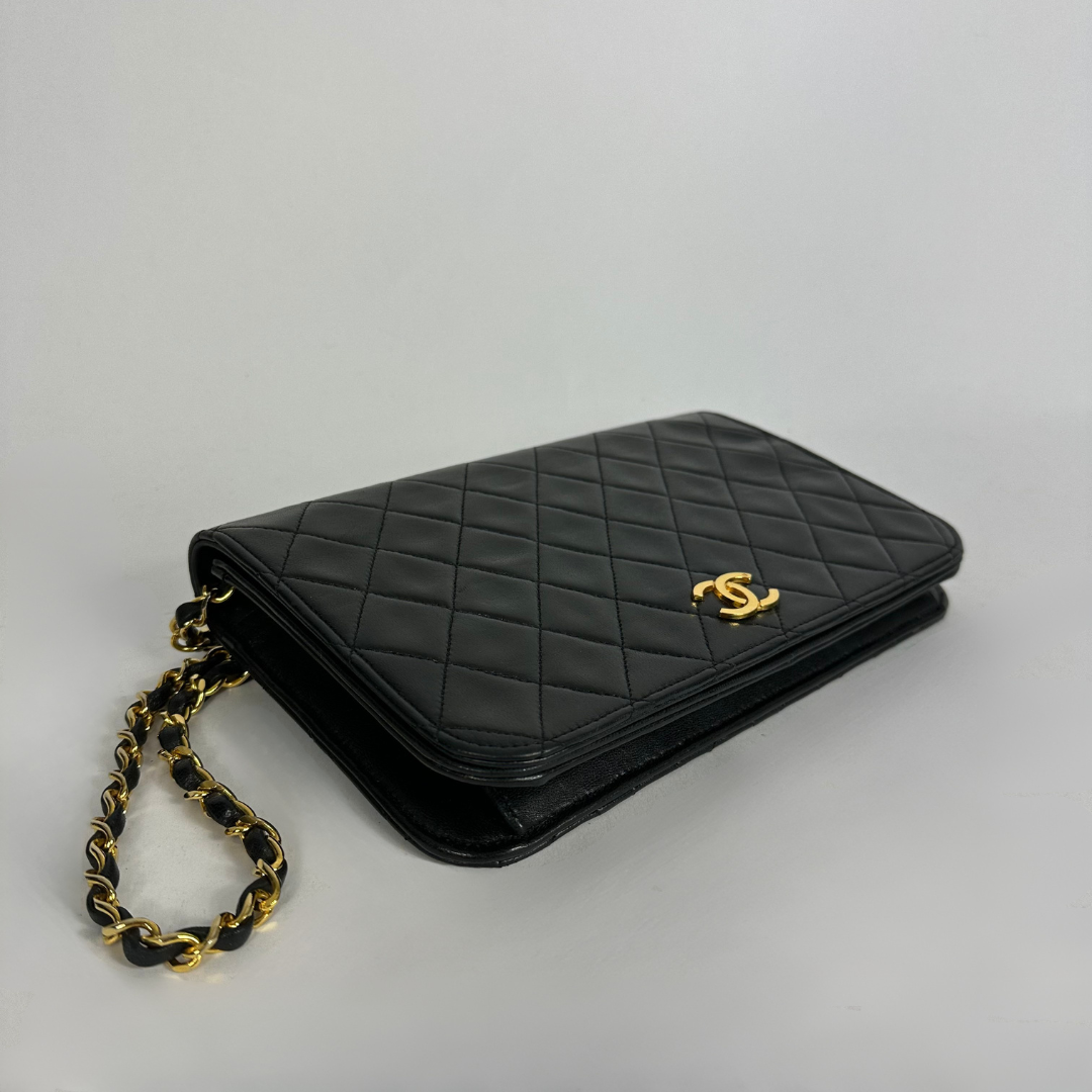 Black Chanel bag on white background