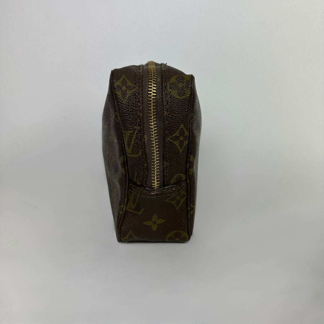 Louis Vuitton toiletry bag in front of white background
