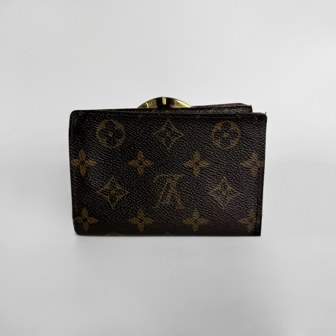 A Louis Vuitton monogram canvas wallet in dark brown with gold-tone hardware, photographed against a neutral light gray background.