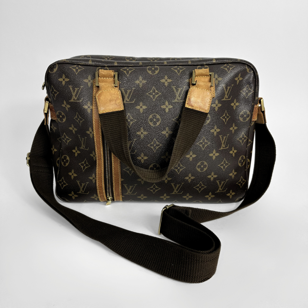 Designer bag with monogram pattern on a light gray background