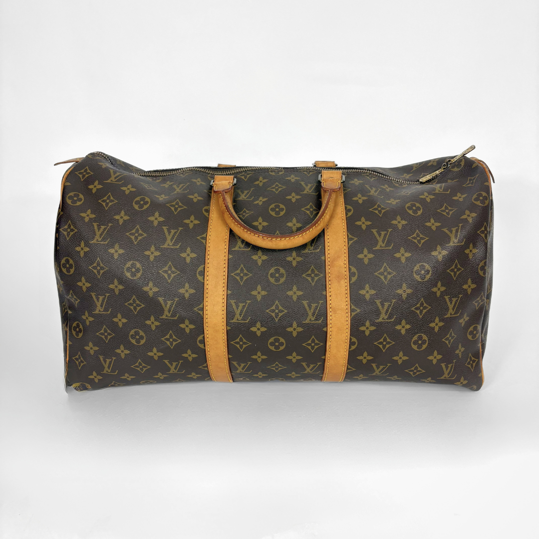 Louis Vuitton monogram duffel bag with brown leather straps on a white background