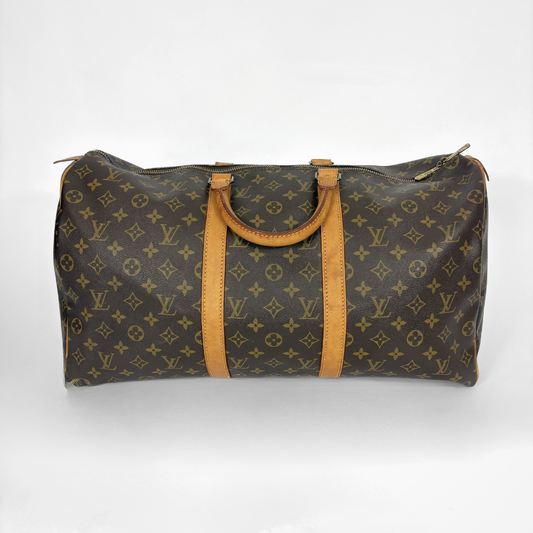 Louis Vuitton monogram duffel bag with brown leather straps on a white background
