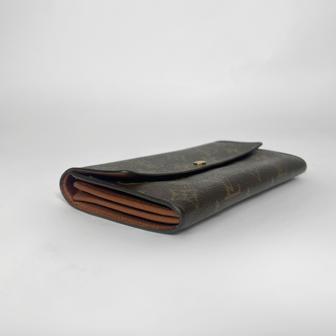Brown leather wallet on a light gray background