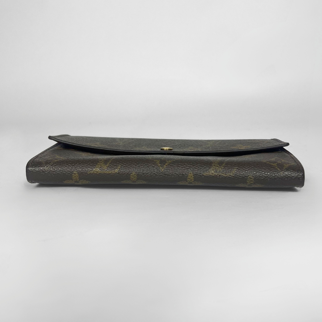 Vintage Louis Vuitton wallet with monogram pattern on a white background
