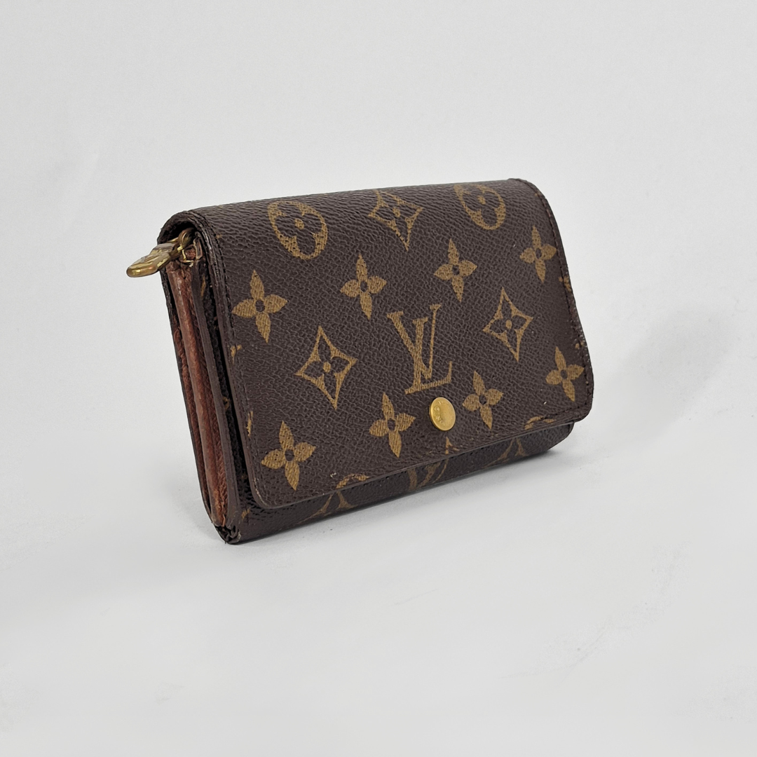 Louis Vuitton wallet with monogram pattern on a white background
