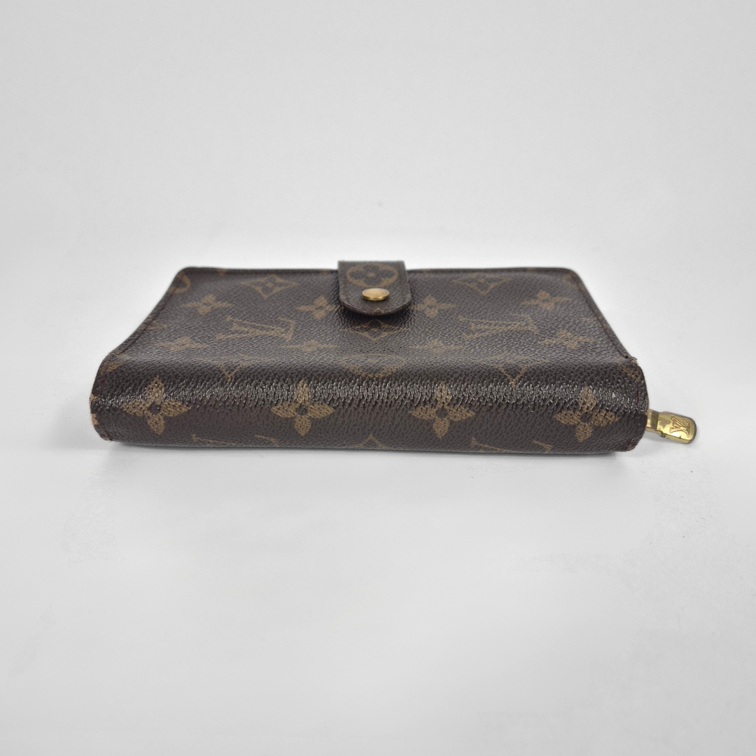 Designer wallet with monogram pattern on a light gray background