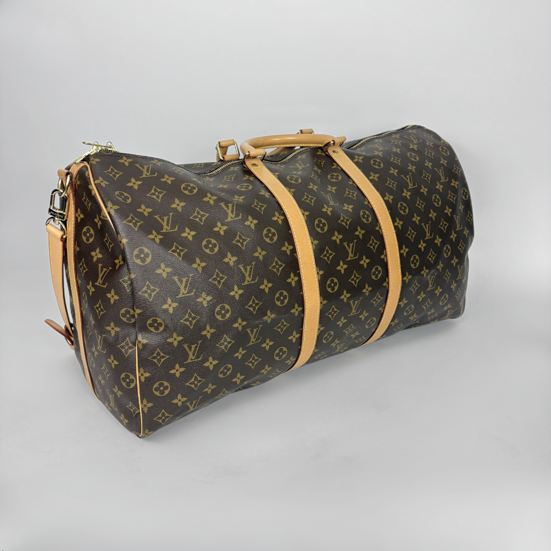 Designer duffel bag with monogram pattern on a gray background