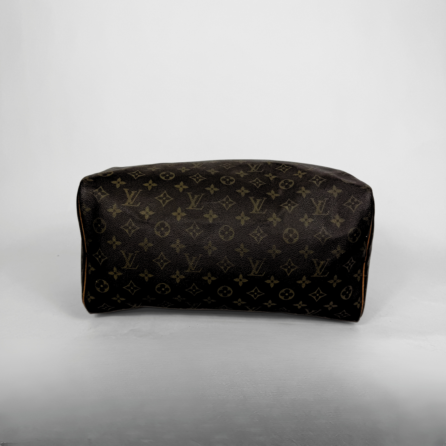Designer handbag with monogram pattern on a light gray background