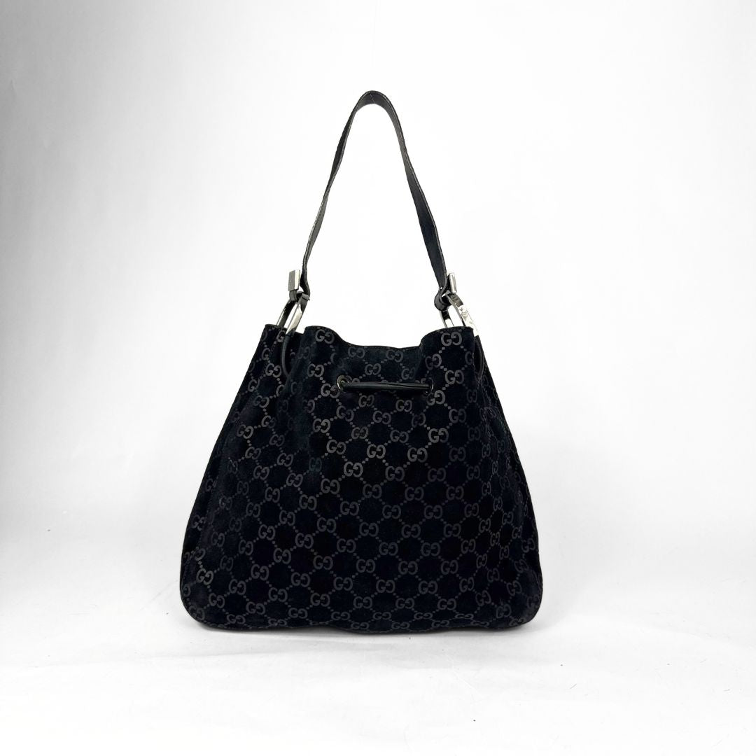 Black patterned handbag on a white background