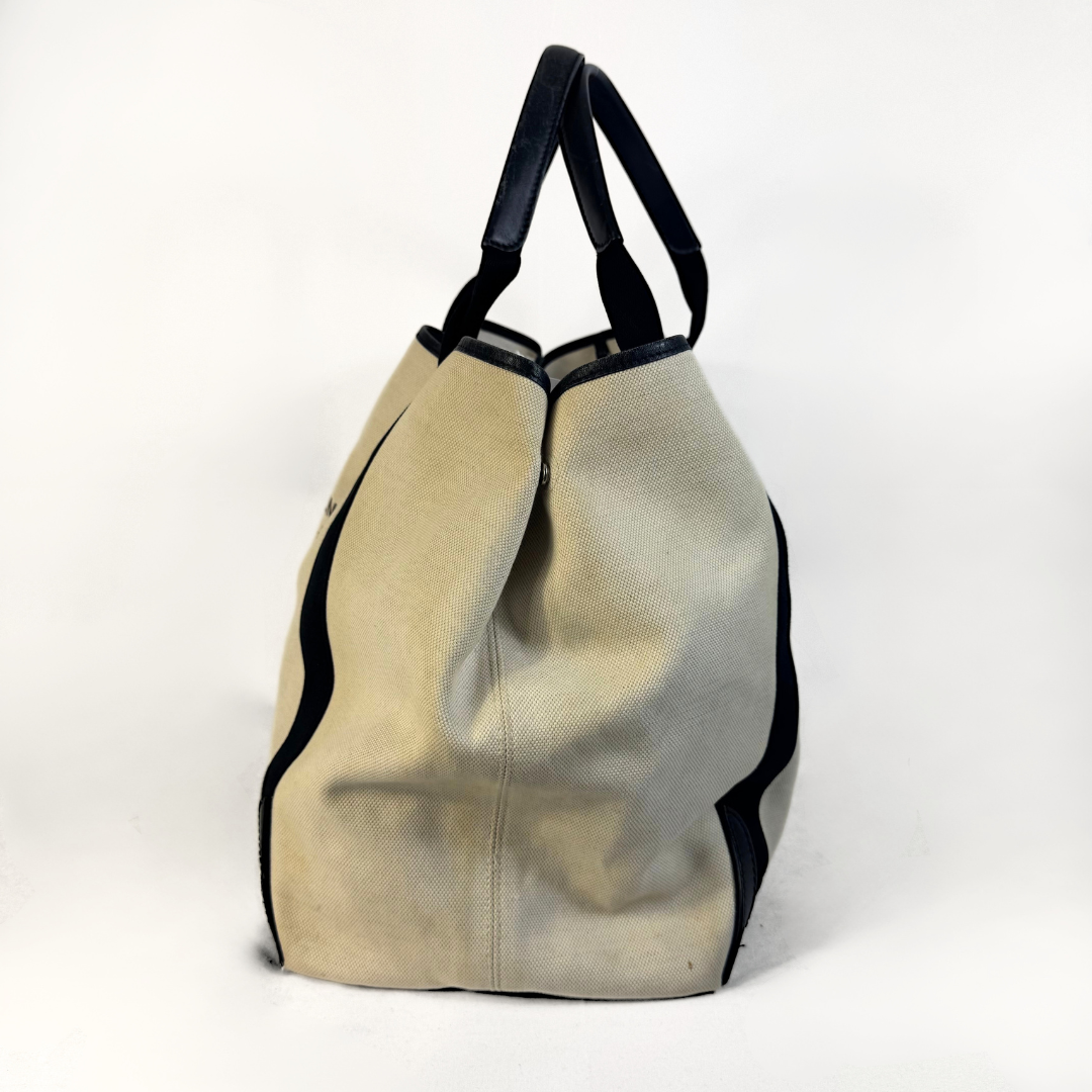 Balenciaga tote bag with black accents on a light gray background