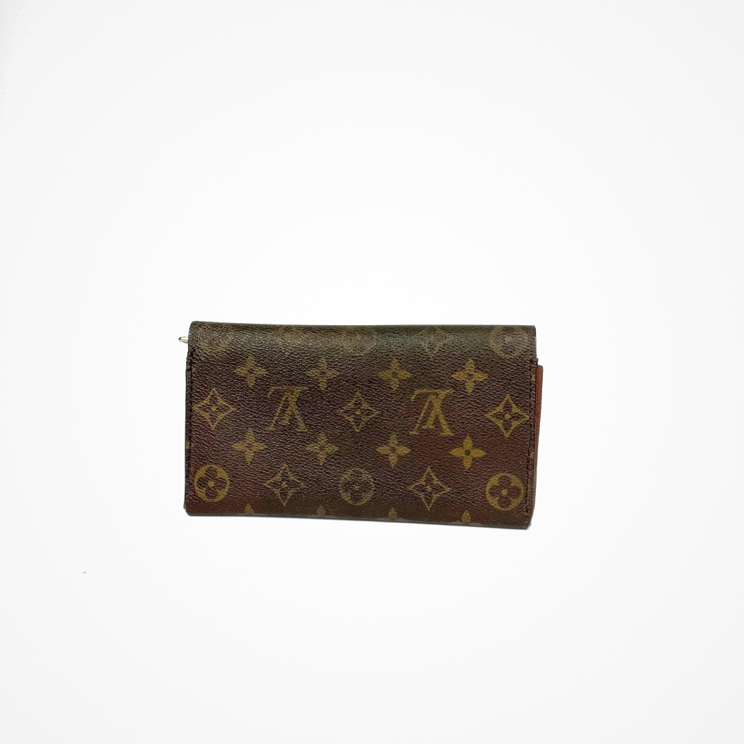 Louis Vuitton Wallet Large with gold monogram pattern on a white background