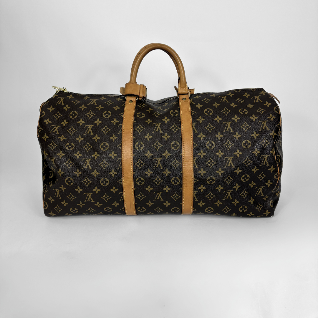 Designer duffel bag with monogram pattern on a white background