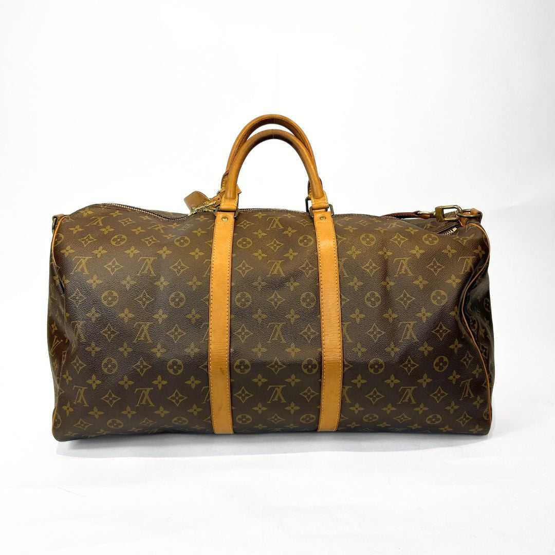 Brown travel bag with yellow accents on a white background
