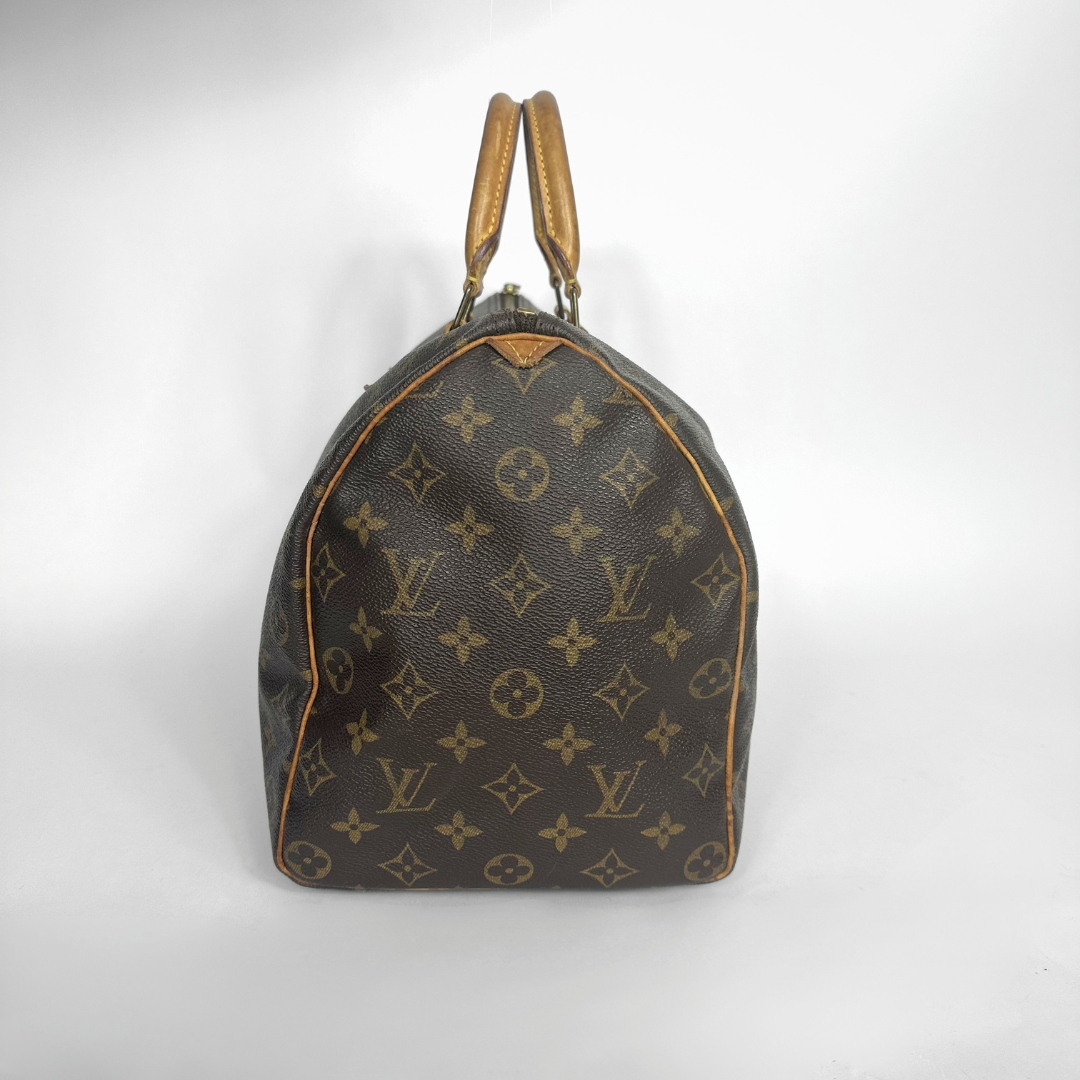 Brown handbag with a monogram pattern on a white background