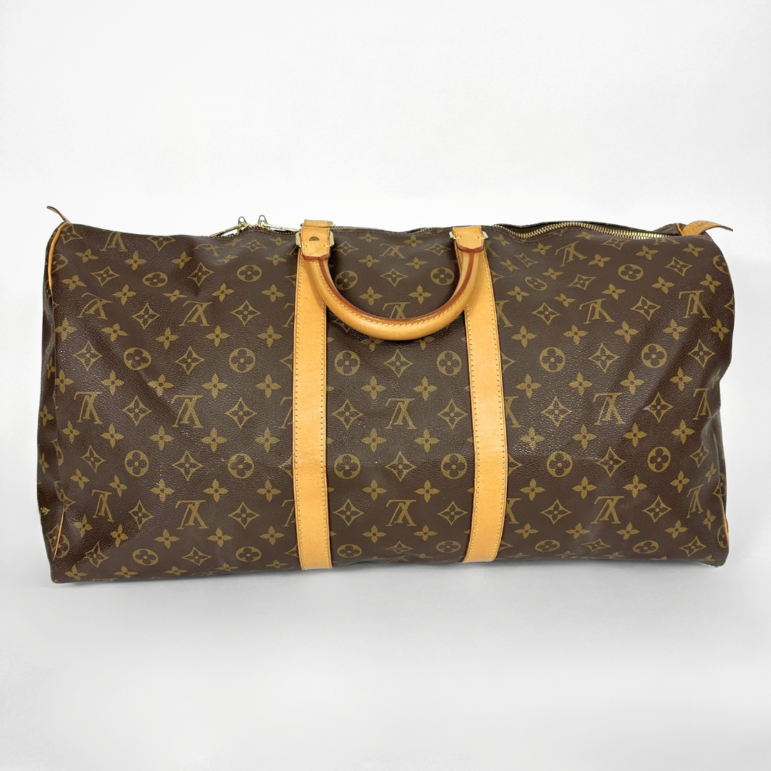 Louis Vuitton monogram duffel bag with tan handles on a white background