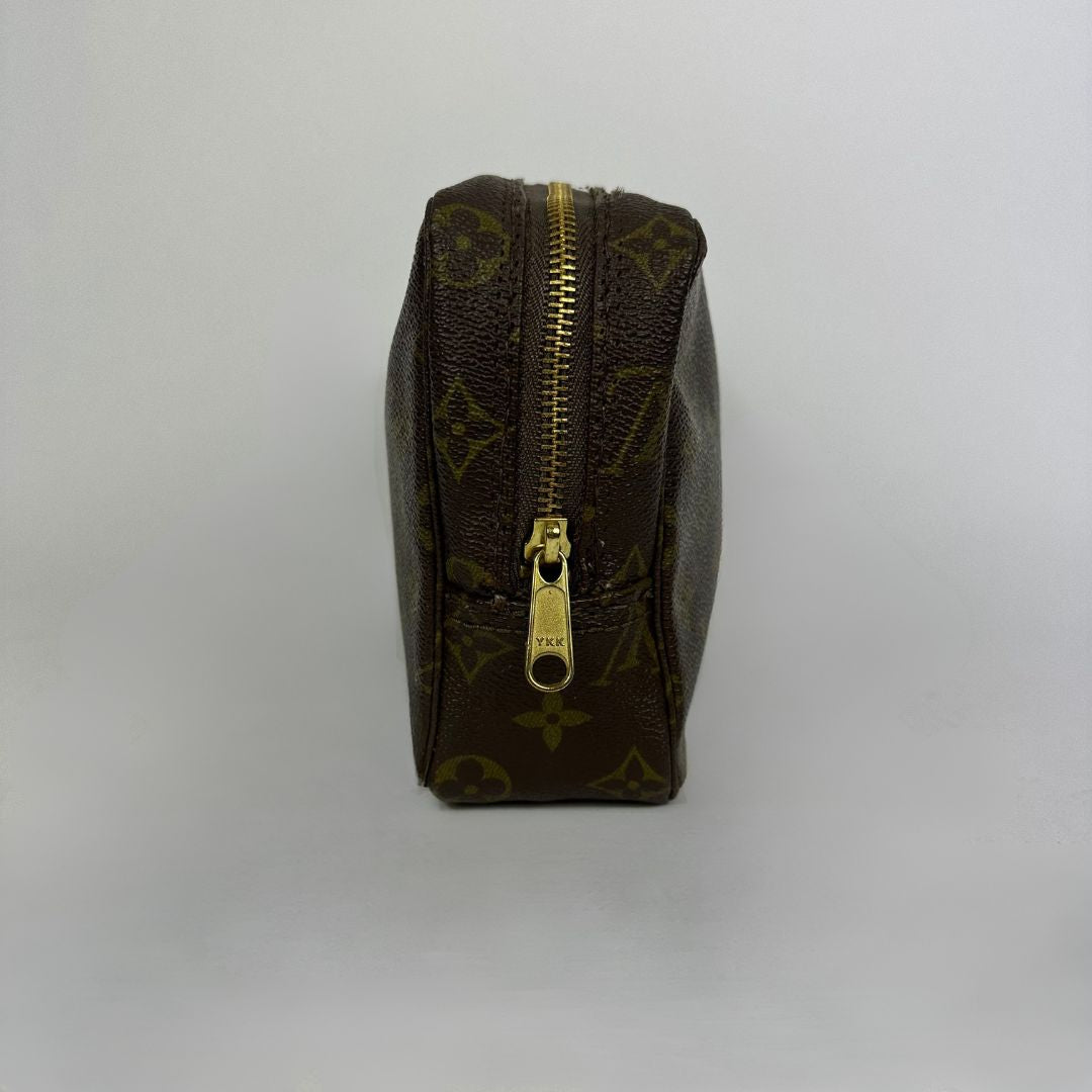 Louis Vuitton toiletry bag in front of white background