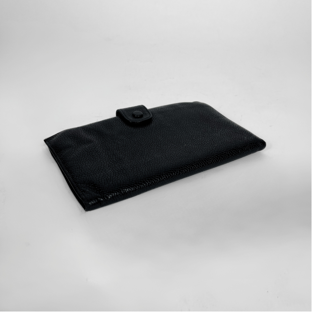 A black textured leather sleeve or pouch with a snap-button closure, photographed on a light gray background.