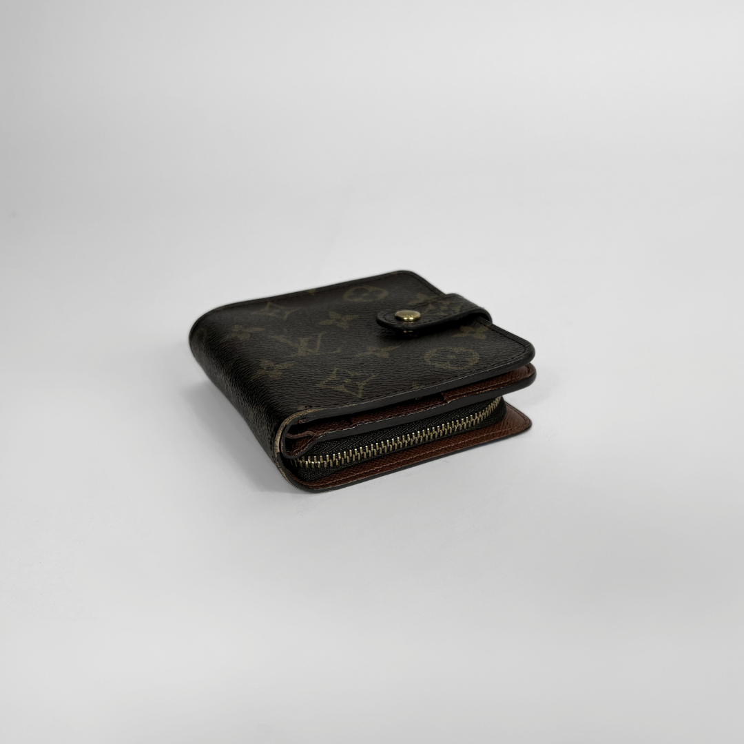 Brown LV wallet with gold accents on a light gray background