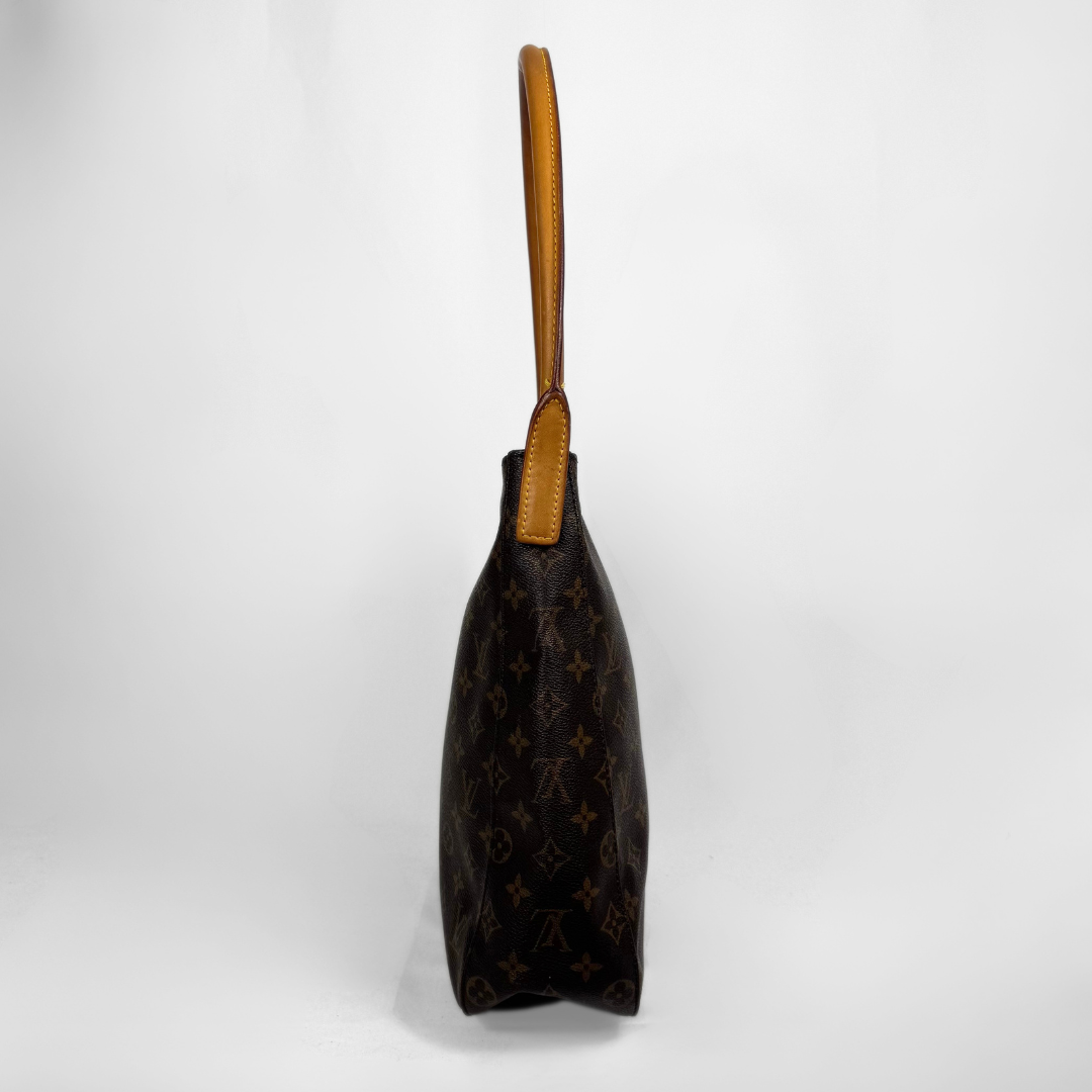 A Louis Vuitton monogram canvas shoulder bag in dark brown with tan leather trim and handle, shown from a side profile view against a light gray background.
